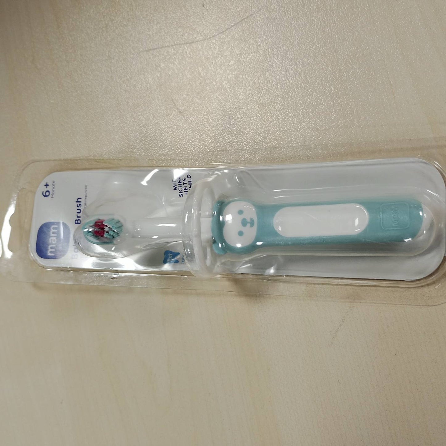 275972 - MAM Furçë dhëmbësh Baby's Brush, furçë për fëmijë me dorezë të shkurtër, për pastrim të butë të dhëmbëve, për fëmijë nga 6+ muaj, ngjyrë turkeze
