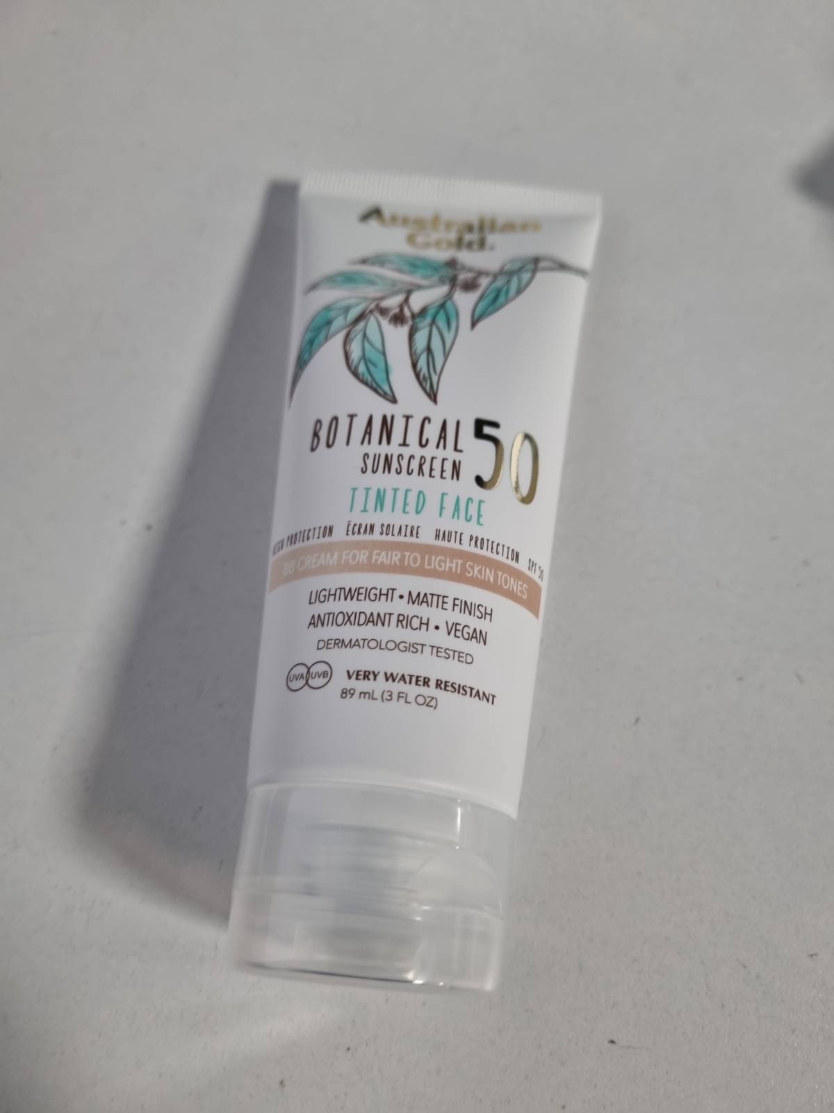 307413 - AUSTRALIAN GOLD Krem për fytyrën me nuancë botanike SPF 50, 88 ml, I lehtë.