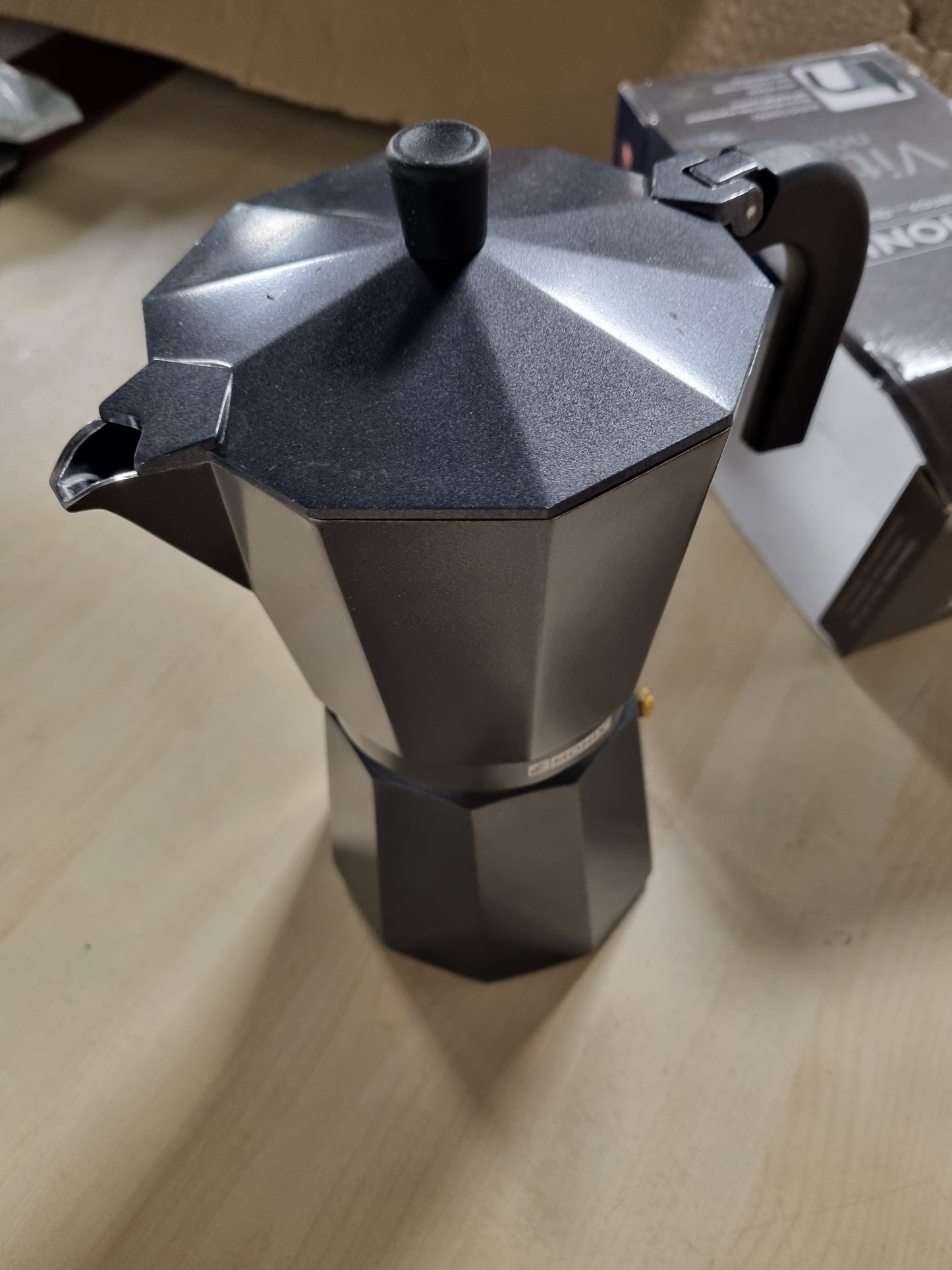 219102 - MONIX Makinë kafeje italiane prej alumini Vitro Noir, kapacitet 12 filxhanësh, dorezë rezistente ndaj nxehtësisë, shtresë jo-ngjitëse, e lehtë për t'u pastruar, e përshtatshme për soba qeramike dhe me gaz, e zezë