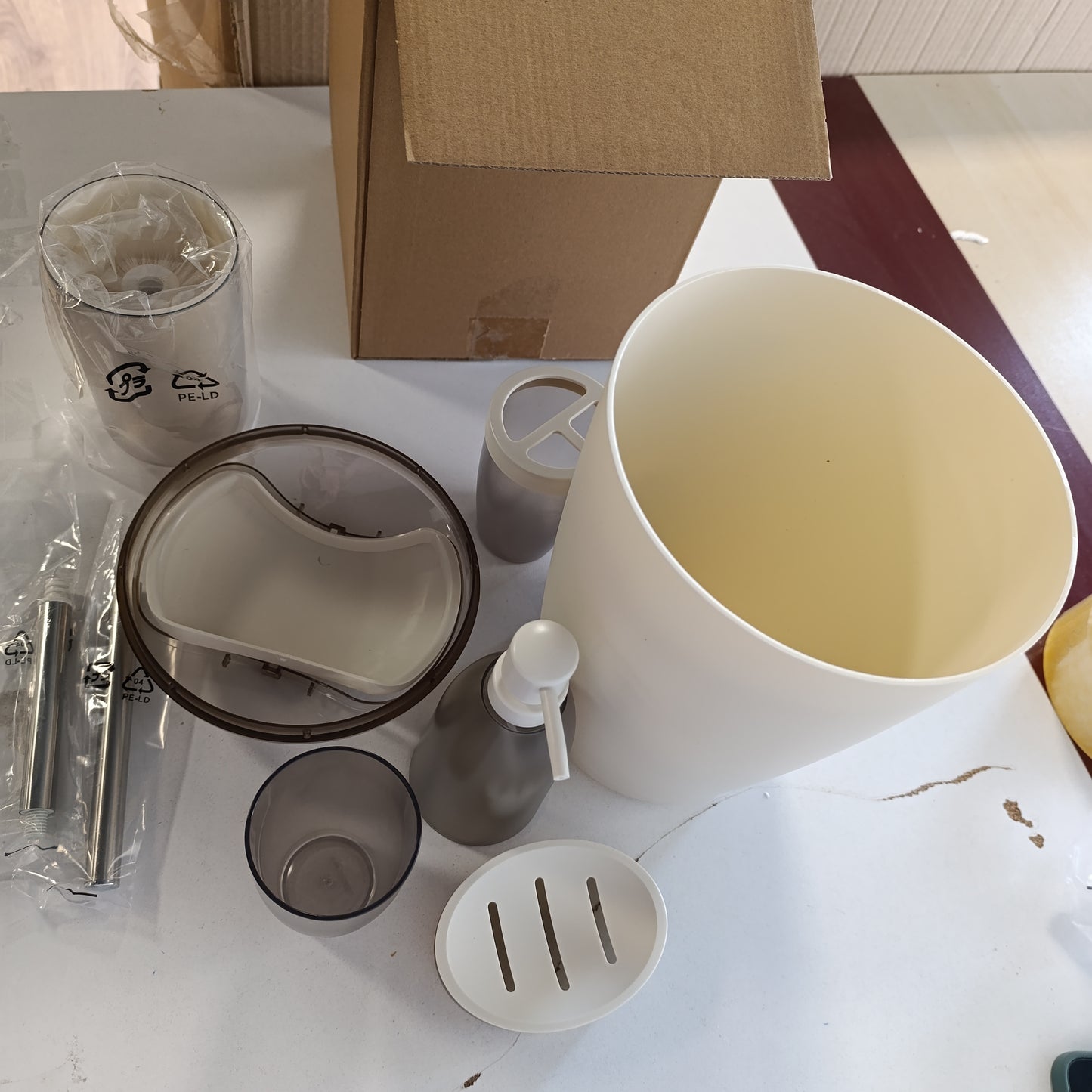 184803 - AMAZON BASICS Set Aksesorësh të Banjës me Mbajtëse Furçe Dhëmbësh, Dispensues Sapuni, Enë Sapuni, Gotë, Kosh Plehrash, Furçë Tualeti dhe Mbajtëse, Ngjyrë Fildishi