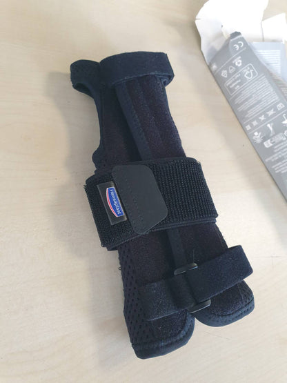 300678 - HANSAPLAST Fashë mbrojtëse stabilizuese për kyçin e dorës, unisex, mbështet dhe lehtëson nyjen
