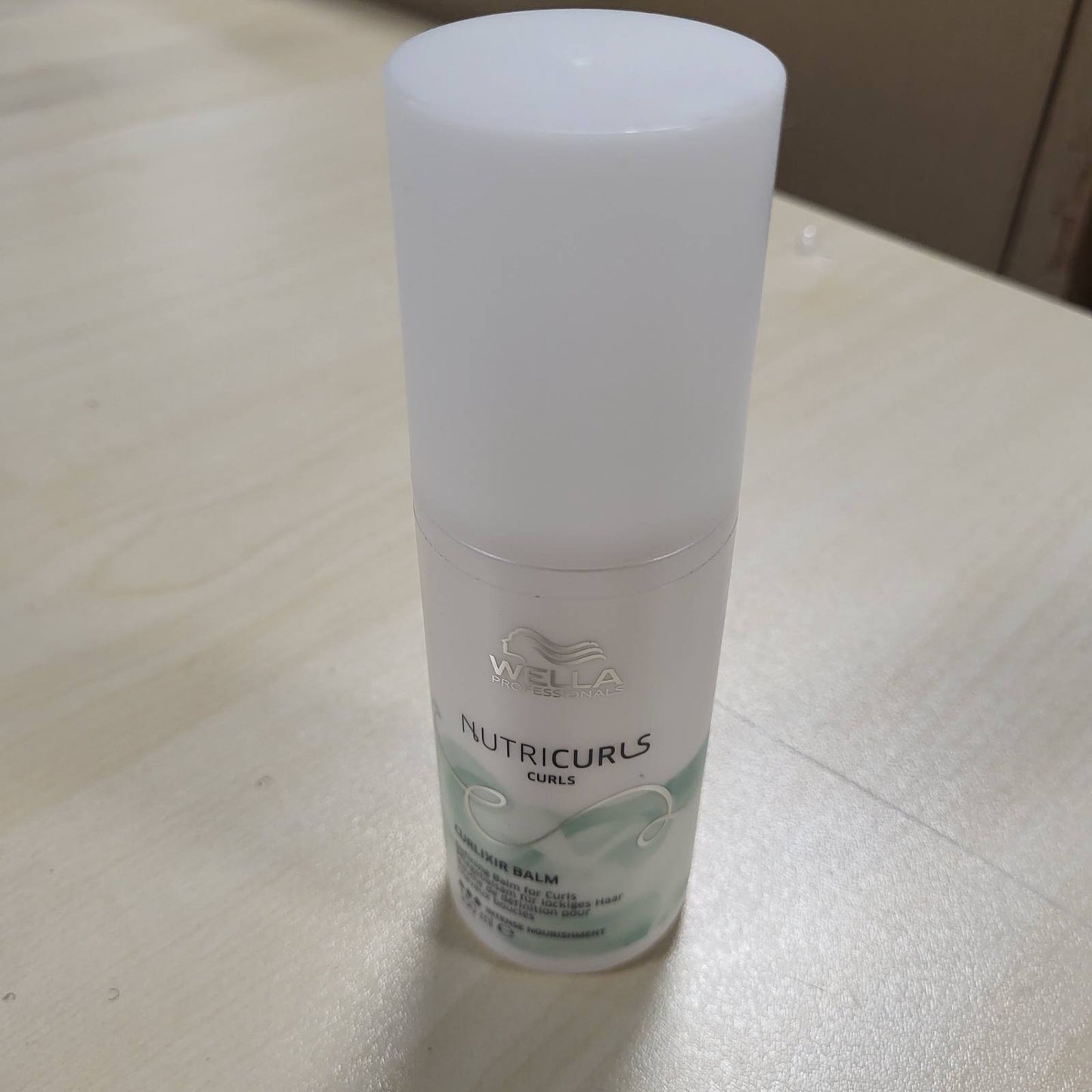 317310 - WELLA PROFESSIONALS Balsam për Flokë Kaçurrela NUTRICURLS Curlixir - 150 ml me Vaj Jojoba