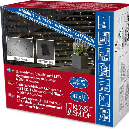 215101 - KONSTSMIDE Dritat LED me rrjetë për përdorim të jashtëm (IP44), funksionojnë me bateri: 4xAA 1.5V (nuk përfshihen), 40 dioda të bardha të ngrohta, me sensor drite dhe kohëmatës 6 orësh dhe 9 orësh, 80 x 80 cm