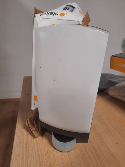 184106 - STEINEL LLAMBË MURORE L 1 S me Detektor Lëvizjeje 180°, Rreze Veprimi 10m, Maksimal 60W, E27, e Zezë, Përfshirë Numrin e Shtëpisë, për Jashtë/Kopsht
