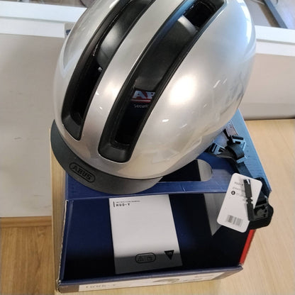 292182 - ABUS Helmetë Urban HUD-Y, L, Dritë LED e pasme magnetike dhe e rikarikueshme, mbyllje magnetike, Argjend 57-61cm