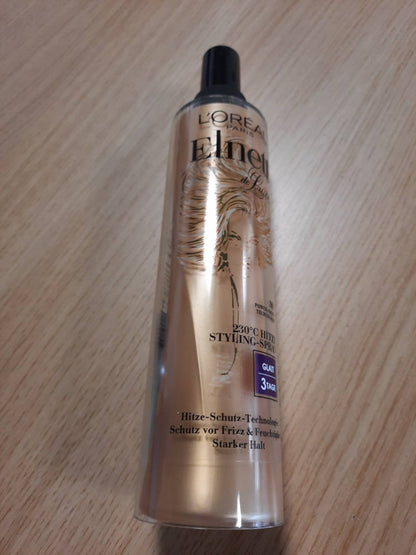 302616 - L'ORÉAL PARIS Elnett Ngrohës Styling Spray, llak flokësh me mbrojtje nga nxehtësia 230°C, kundër kaçurrelave, stilim afatgjatë - deri në 72 orë, kujdeset dhe zgjat stilimin e flokëve me kompleks termo-keratinë, 170 ml.