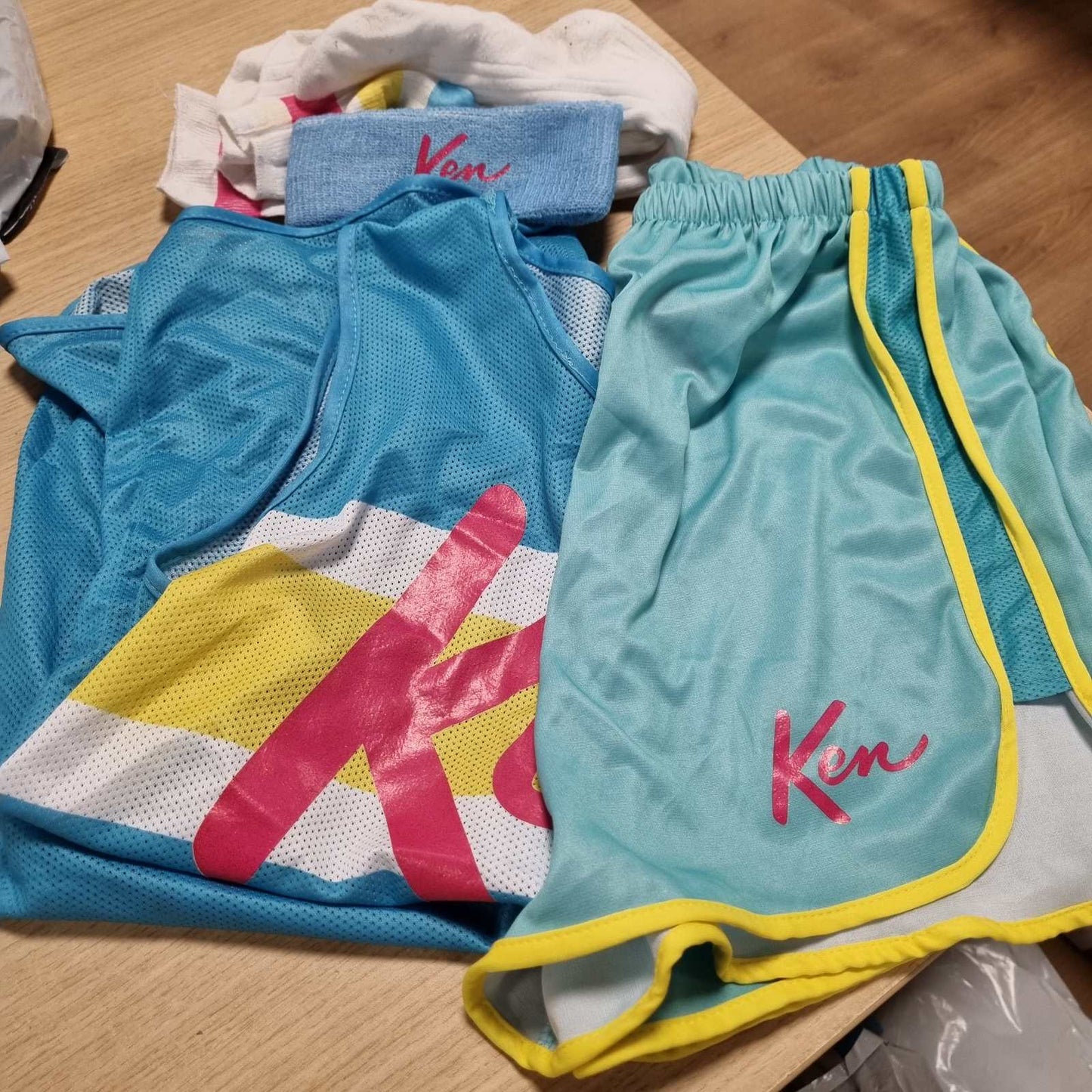 316420 - RUBIE Kostum Zyrtar për Aerobikë Ken - Barbie për të Rritur, Madhësi Standarde, kostum me bluzë të kuqe, pantallona të shkurtra, çorape të larta sportive.