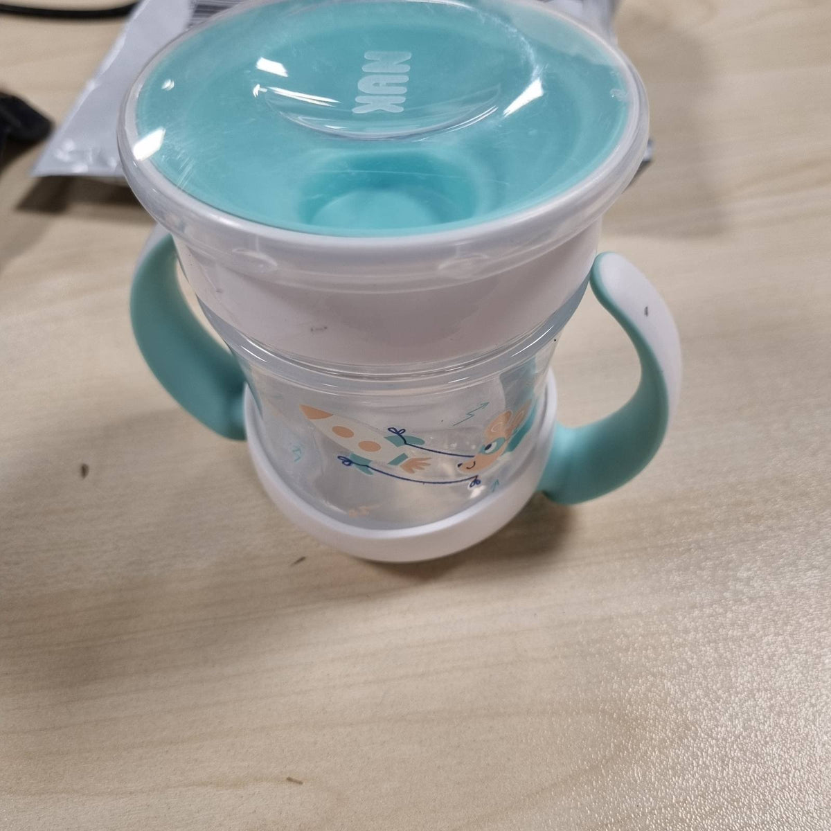 303452 - NUK Mini Magic Cup Filxhan me Sippy Cup, 160 ml, 6+ Muaj, Pa BPA, Ngjyrë bruz