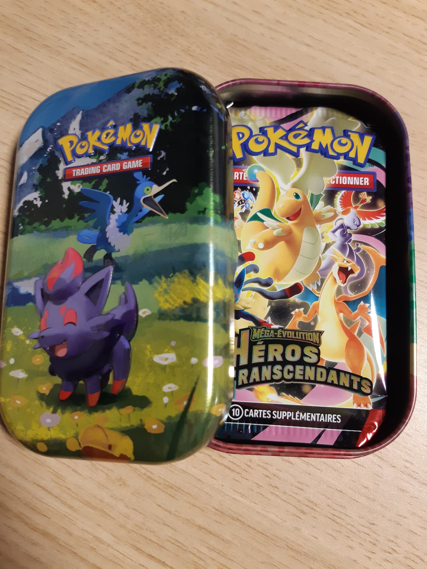 141562 - Pokémon: Mega Evolution Mini Box – Transcendent Heroes – Zorua dhe Nigosier (1 faqe stickers, 1 kartë arti dhe 2 paketa përforcuese).