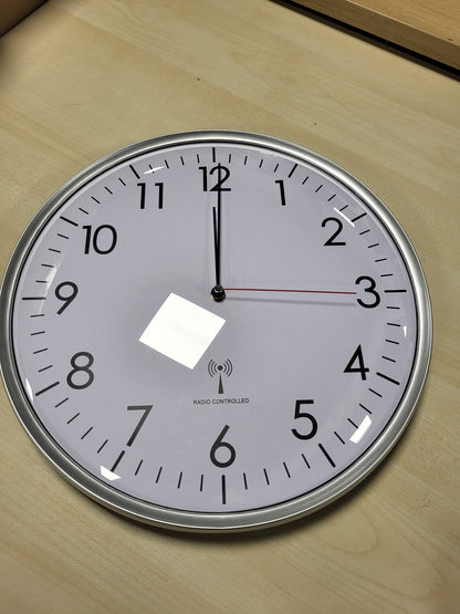 256096 - TFA DOSTMANN Orë muri analoge me radio, e bardhë/argjendtë, përmasat 330 x 50 mm, e përshtatshme për kuzhinë dhe zyrë