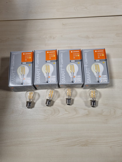 241136 - LEDVANCE Llampa LED inteligjente me teknologji Wi-Fi, bazë E27, ngjyrë e bardhë e ngrohtë (2700K), në formë pike loti, filament transparent, zëvendësim për llambat inkandeshente 40W, e kontrollueshme me Alexa dhe Google, pako me 4